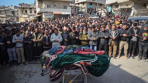 Village male residents pray during the funeral of four Syrian security force members killed in clashes with loyalists of ousted President Bashar Assad in coastal Syria, in the village of Al-Janoudiya, west of Idlib, Saturday, March 8, 2025.