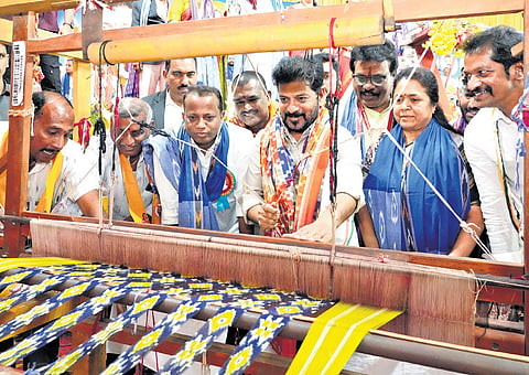 Chief Minister A Revanth Reddy tries his hand at handloom weaving during
the Akhila Bharatha Padmashali Mahasabha in Hyderabad on Sunday