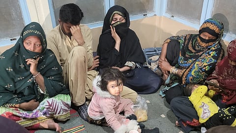 Freed train passengers gather at the Mach railway station after Pakistani security forces freed nearly 80 passengers following a security operation against armed militants who ambushed the train on March 11, 2025.