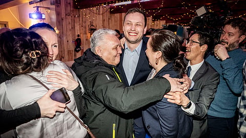 Chairman of Demokraatit, Jens-Frederik Nielsen, center, celebrates during the election party at Demokraatit by cafe Killut in Nuuk, early Wednesday, March 12, 2025.
