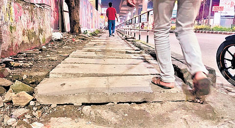 A poorly-maintained footpath on MG Road