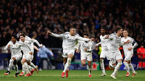 Real Madrid's French forward #09 Kylian Mbappe (C) celebrates with teammates after winning in a penalty shootout the UEFA Champions League Round of 16 second leg football match between Club Atletico de Madrid and Real Madrid CF at the Metropolitano stadium in Madrid on March 12, 2025.