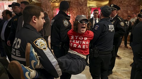 New York Police officers arrest a demonstrator from the group, Jewish Voice for Peace, who protested inside Trump Tower in support of Columbia graduate student Mahmoud Khalil, Thursday, March 13, 2025, in New York.