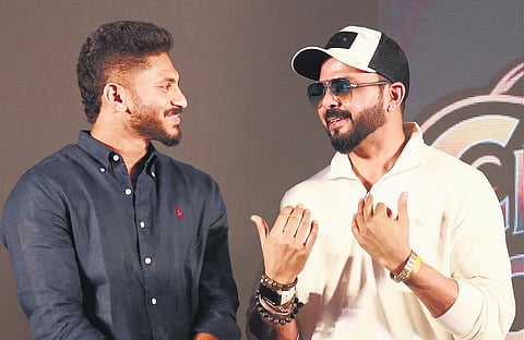 Cricketers S Sreesanth and Basil Thampi share a light moment during the launch of CCF Premier League at hotel Holiday Inn in Kochi on Monday