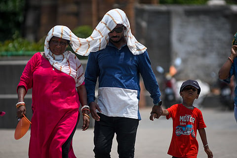 People cover their head to protect themsleves from heat in Bhubnaeswar