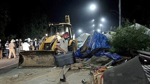 Temporary structures set up by agitating farmers being dismantled during an eviction drive by the Punjab Police to remove them from the Shambhu border
