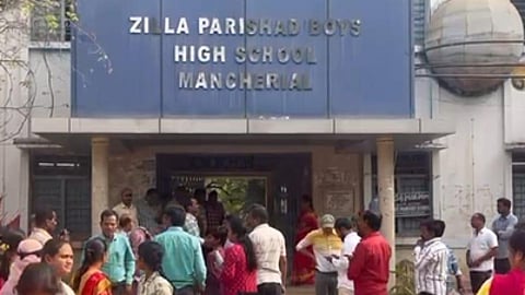 Parents wait outside the ZPHS in Mancherial where Hindi question paper was issued instead of Telugu question paper during the SSC exams.
