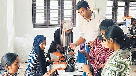 Students stitching cloth bags at Maharaja’s College in Kochi under the ‘Earn While You Learn’ project