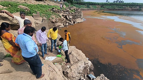 Officials from TNPCB collect samples from the Bhavani River on Thursday.