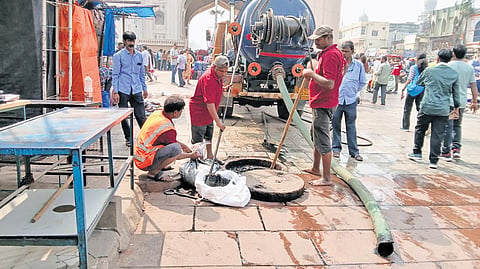 Hyderabad Metropolitan Water Supply and Sewerage Board staff carry out desilting works as part of special drive in Charminar on Thursday
