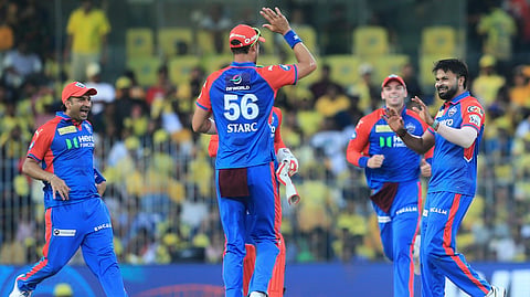 Delhi Capitals' Mukesh Kumar, left, celebrates with teammates after the dismissal of Chennai Super Kings' Rachin Ravindra