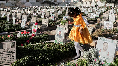 A Yemeni girl visits the graves of Houthis during Eid al-Fitr marking the end of the holy fasting month of Ramadan in Sanaa, Yemen, Sunday, March 30, 2025.