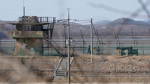 In this photo from February 18, 2025, South Korean army soldiers patrol along the barbed-wire fence in Paju, South Korea, near the border with North Korea.