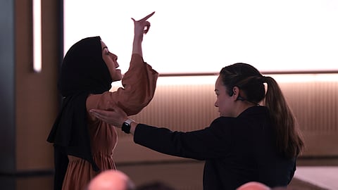A pro-Palestinian demonstrator, Ibtihal Aboussad, is escorted away by security as they interrupt Microsoft AI CEO Mustafa Suleyman during a presentation of the company's AI assistant, Copilot, ahead of a 50th Anniversary presentation at Microsoft headquarters, Friday, April 4, 2025, in Redmond.