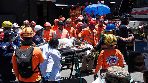 Rescue workers carry a person pulled from the wreckage of the Jet Set nightclub after its roof collapsed during a merengue concert in Santo Domingo, Dominican Republic,