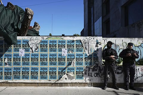 Signs that read in Spanish "Justice to God," cover a wall where police stand guard outside the court. It is here the medical team that treated the late soccer star Diego Maradona is on trial facing charges of homicide by negligence in San Isidro, on the outskirts of Buenos Aires, Argentina, Thursday, April 3, 2025.