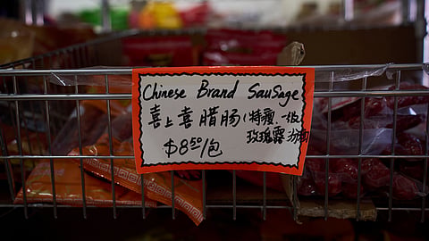A handwritten price tag for sausage imported from China is seen at a grocery market in the Chinatown neighborhood of Los Angeles, Friday, April 11, 2025.