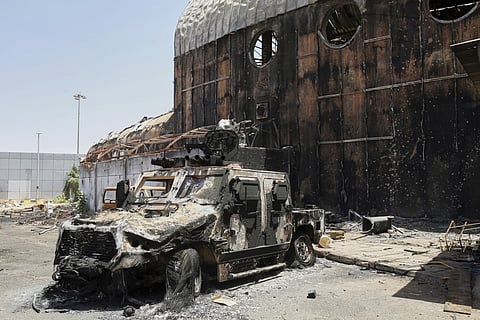 A burned military vehicle sits at Khartoum international airport a day after it was recaptured from the paramilitary Rapid Support Forces (RSF) in Khartoum, Sudan, Thursday, March 27, 2025.