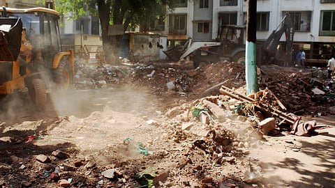 A bulldozer being used to demolish an allegedly illegal dargah, in Nashik district, Maharashtra, Wednesday, April 16, 2025.