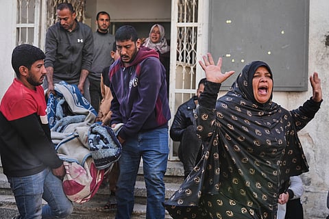 A Palestinian woman reacts as others carry the body of their relative, killed in an Israeli airstrike, in preparation for burial at Shifa Hospital in Gaza City, Wednesday, April 16, 2025.