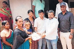Andhra Pradesh deputy CM Pawan Kalyan distributing footwear to tribal families.