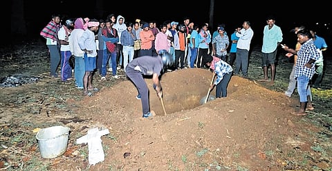 Family members digging the burial site at midnight
