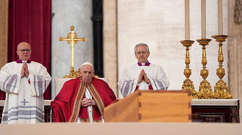 Pope Francis sits by the coffin of late Pope Emeritus Benedict XVI in St. Peter's Square during a funeral mass at the Vatican, on Jan. 5, 2023.