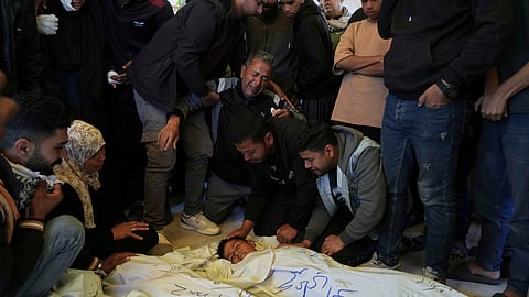 Mourners grieve over the body of Palestinian child Mohammad Abu Nada, killed in an Israeli army airstrike, during his funeral in Khan Younis, southern Gaza Strip, on Saturday, April 19, 2025.