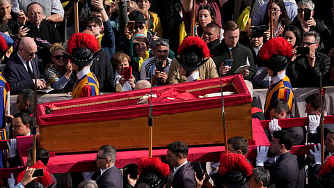 The ceremony with the Pope Francis' body, who will lie in state at St. Peter's Basilica for three days, pass through the crowd at the Vatican, Wednesday, April 23, 2025.