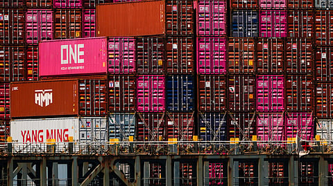 Shipping containers sit on the container ship One Manhattan at Port Jersey, Friday, April 18, 2025