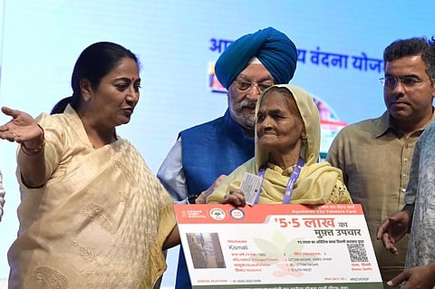 Delhi Chief Minister Rekha Gupta and Union Minister Hardeep Singh Puri during the distribution of Ayushman Bharat cards
