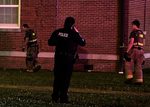 A police officer and Elizabeth City firefighters are seen outside Bias Hall at around 1 a.m., Sunday, April 27, 2025, following reports of a gunfire on the Elizabeth City State University campus, in Elizabeth City, N.C.