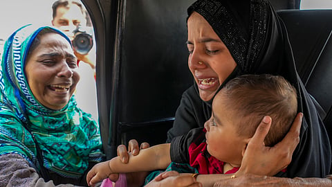A Pakistani national woman gets emotional while leaving for Pakistan as her son with Indian nationality was stopped by the authorities to go with her, at the Attari-Wagah border checkpost near Amritsar, Tuesday, April 29, 2025.