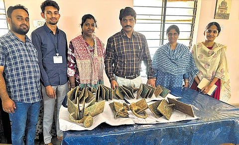 ASI officials display nine sets of copper plates, unearthed from a graveyard in Kodada. The copper plates are believed to be over eight centuries old