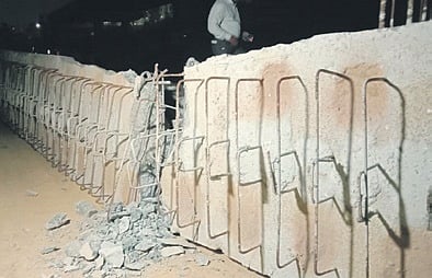 The collapsed concrete slab lies at the construction site