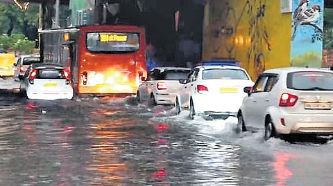 Vehicles wading through waterlogged roads on Saturday.
