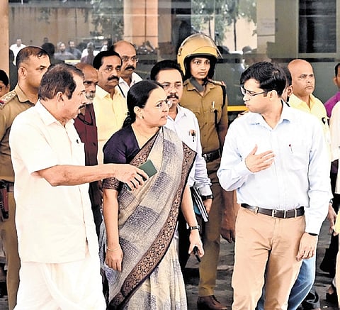 Health Minister Veena George speaks to the district collector and other officials after inspecting the emergency block of the Kozhikode Medical College Hospital