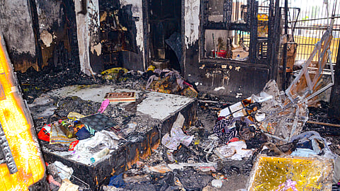 Charred remains of goods after a fire broke out in a building, in Kanpur, Sunday, May 4, 2025. Five members of a family were killed.