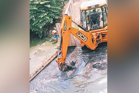 An earthmover removes silt from Kogilu Lake in Yelahanka
