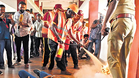 Mock drill by Fire and Rescue Services personnel and civil defence volunteers in progress at the Ernakulam collectorate in Kakkanad on Wednesday