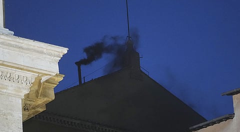 Black smoke billows from the chimney of the Sistine Chapel during the cardinals' conclave to elect a new pope, at the Vatican, Wednesday, May 7, 2025.