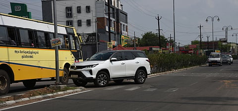A car driver tries to get to the opposite lane, taking advantage of the lack of safety barriers on the median on the Chennai NH near Thiruvanaikovil.