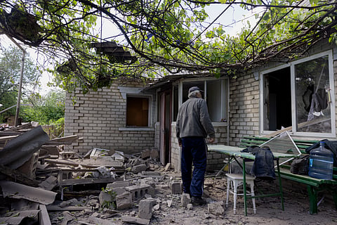 A local resident looks at a damaged private house after Russian shelling in Kramatorsk, Donetsk region on May 11, 2025, amid the Russian invasion of Ukraine.
