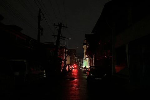Vehicles stand parked on a road during blackout at the time of the military conflict between India and Pakistan, in Srinagar, J&K.