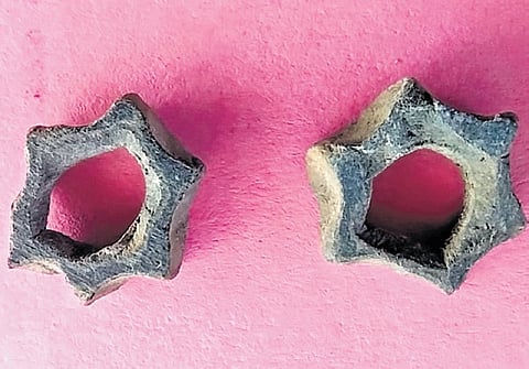 A pair of star-shaped terracotta ornaments unearthed at Vembakottai on Monday