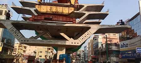 Precasts being lifted to make the flyover in Ejipura.