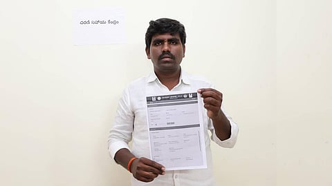 Begari Shivaiah, a farmer from Gundlamachanoor village in Hathnoora mandal, is seen displaying the pattadar passbook issued to him by the Collector at the Collectorate. He received the passbook after six years, as his land had been listed under the prohibited category in Hathnoora mandal.