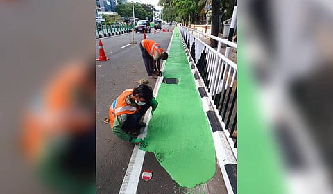 Workers painting the cycle track along the Althara - Thycaud stretch in Thiruvananthapuram on Monday.
