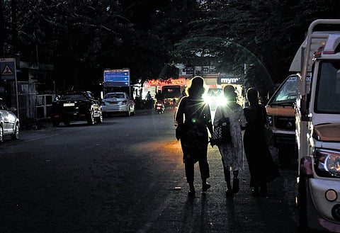 Women walk through the dimly lit Manappattiparambu Road at Kaloor in Kochi. There are no streetlights on the stretch, posing a threat to both pedestrians and motorists