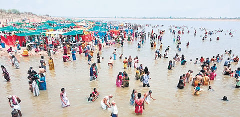 Devotees take holy dips on the third day of Saraswati Pushkaralu at Triveni Sangam in Kaleshwaram on Saturday